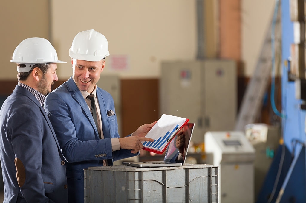 Financial advisor showing graph at businessman.